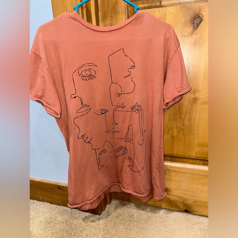 rust colored graphic tee with abstract faces